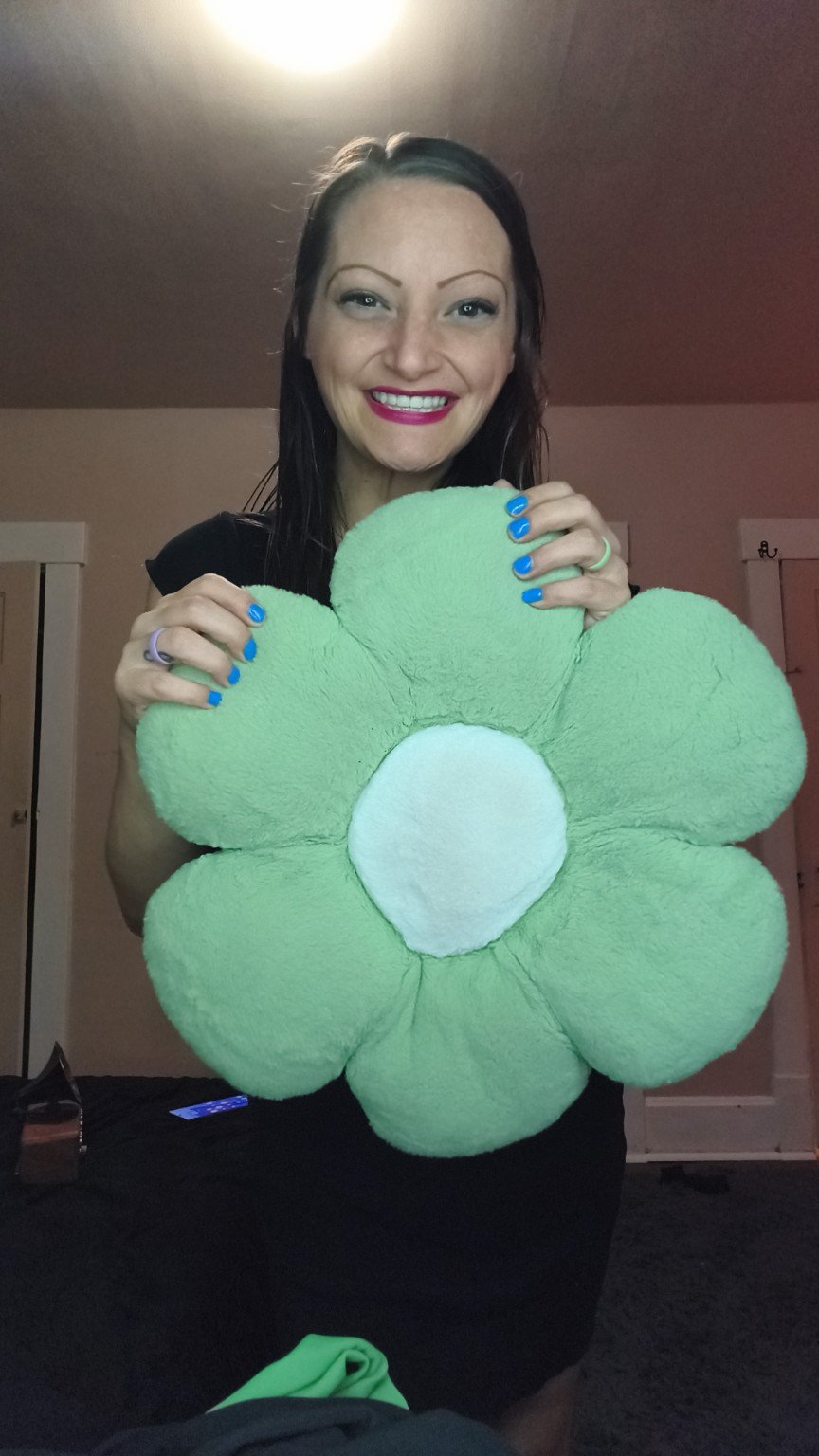 Ren holding a large green flower plush pillow